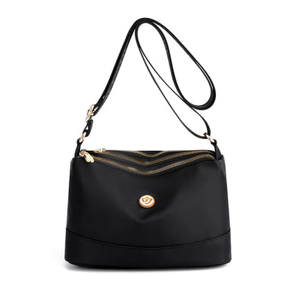 Minimalistisk, romslig skulder- og crossbody-veske i nylon