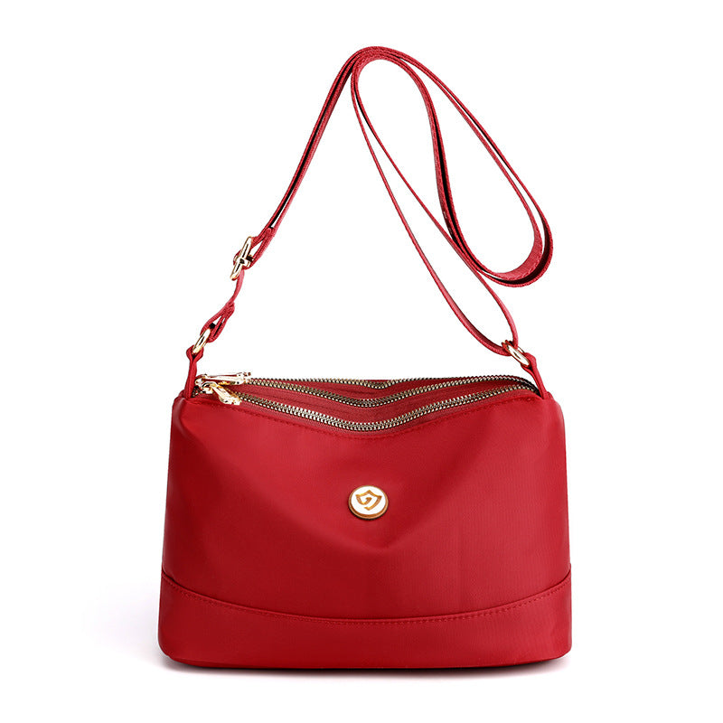 Minimalistisk, romslig skulder- og crossbody-veske i nylon