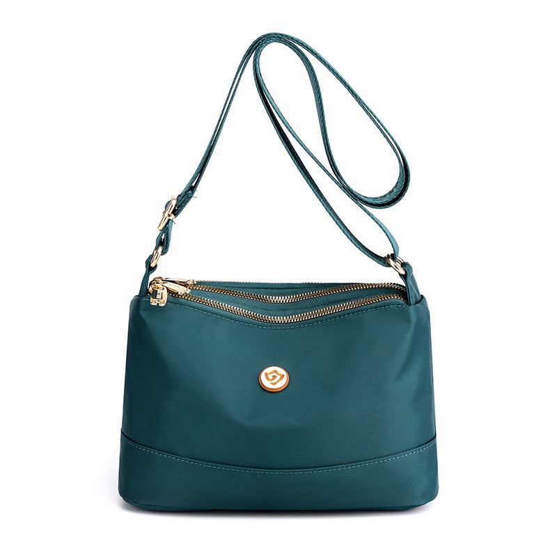 Minimalistisk, romslig skulder- og crossbody-veske i nylon