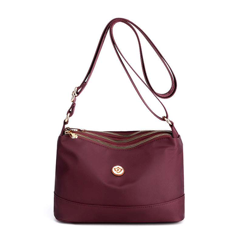 Minimalistisk, romslig skulder- og crossbody-veske i nylon