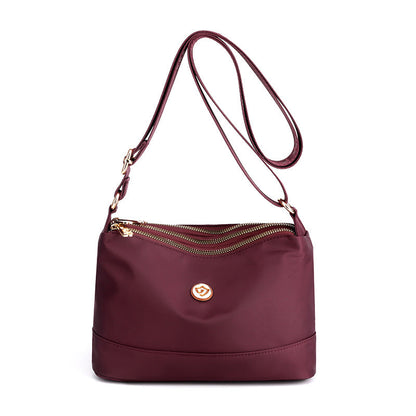 Minimalistisk, romslig skulder- og crossbody-veske i nylon