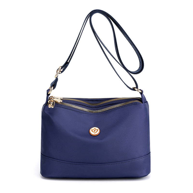 Minimalistisk, romslig skulder- og crossbody-veske i nylon