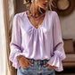 Elegant ensfarget bluse med V-hals for damer