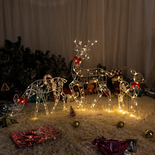 Julelys med hvitt glitter og reinsdyr